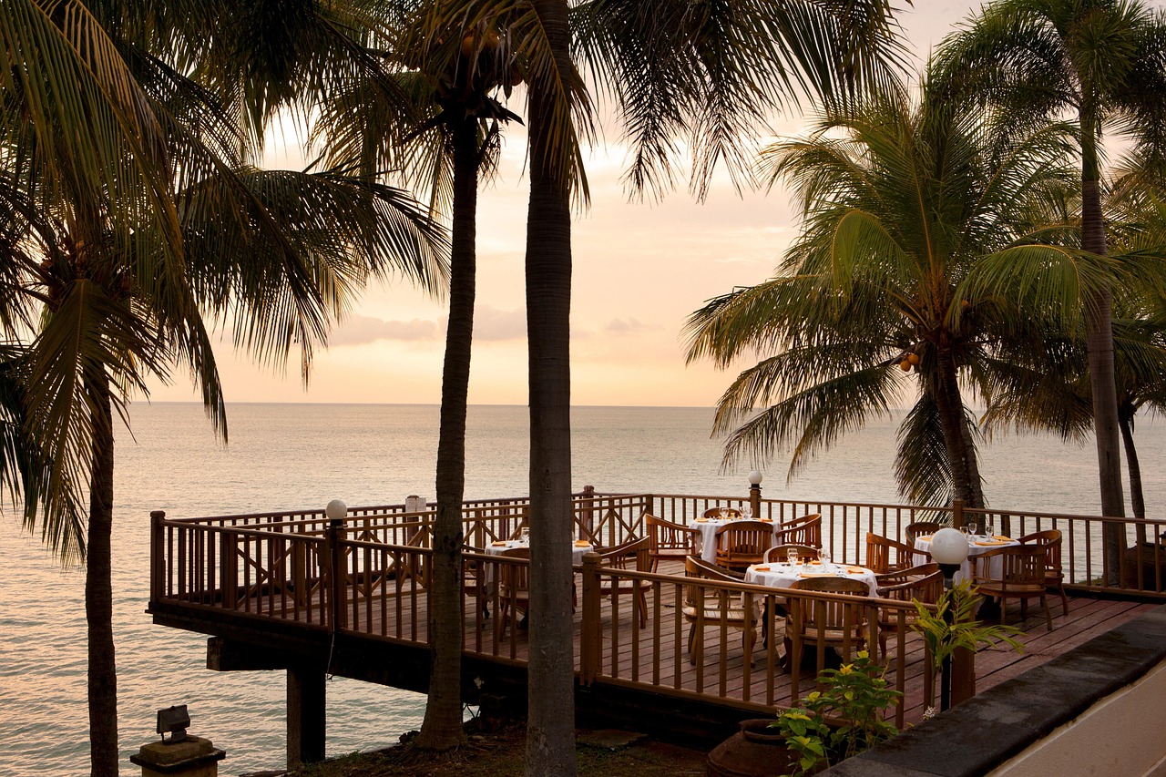 Tables and chairs on a patio over the ocean